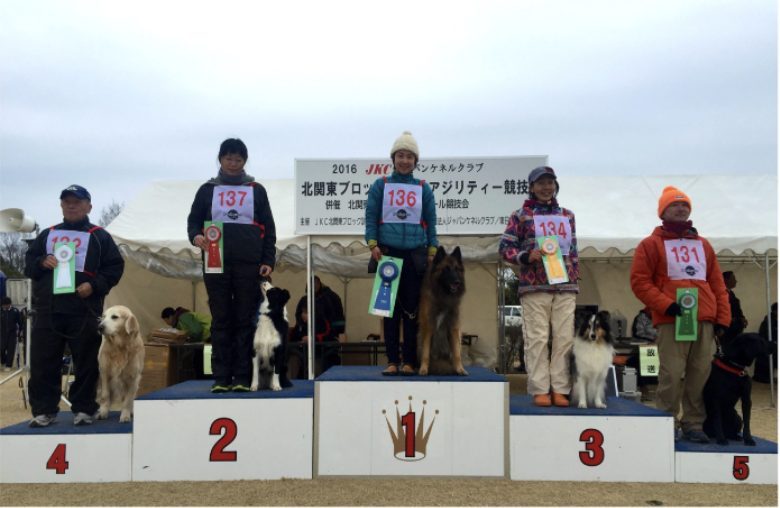ドッグスポーツ競技会で1位の表彰台に立つ長和ゆかりと愛犬リーフィ
