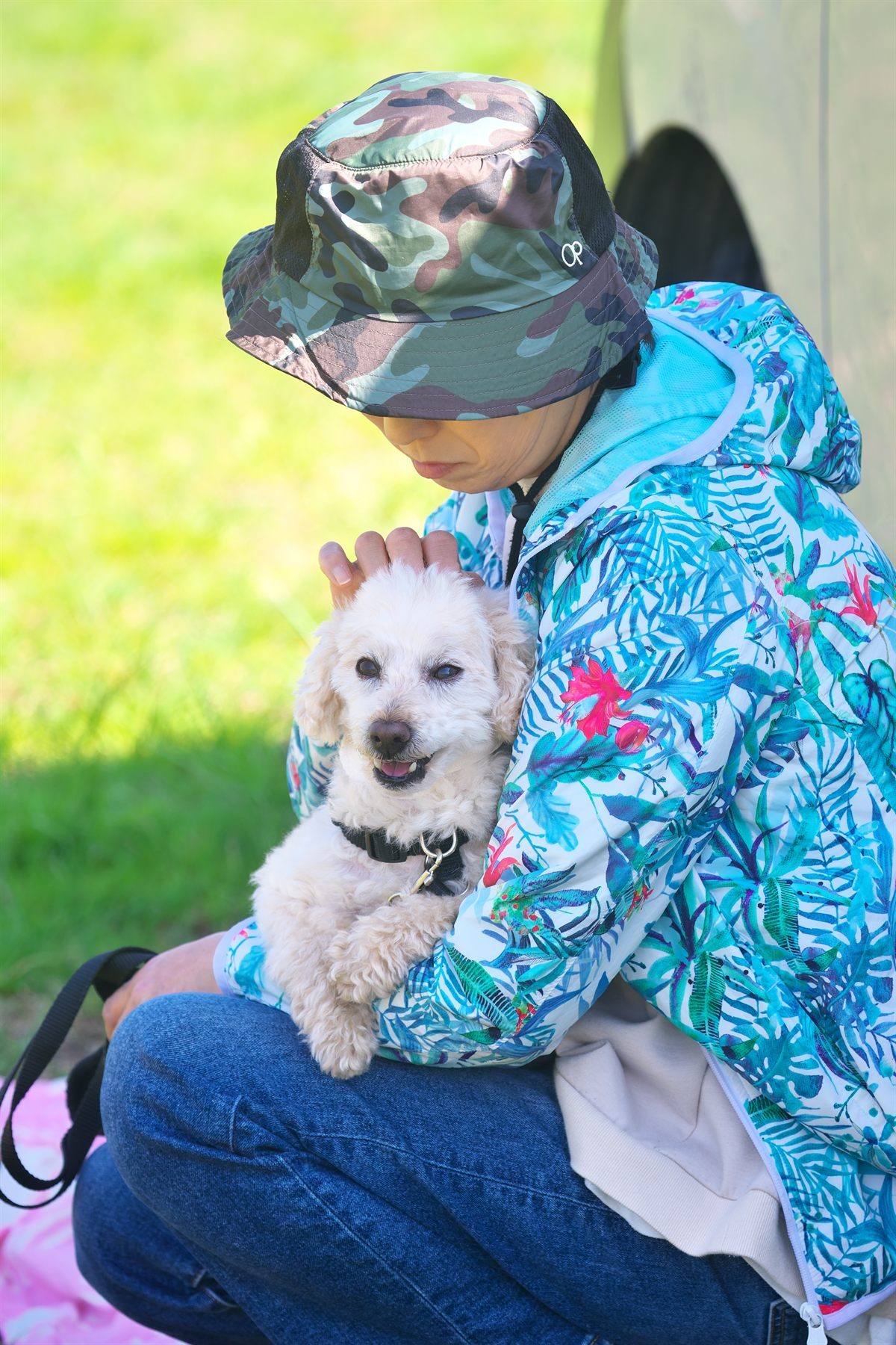 ママに抱かれて落ち着いている犬